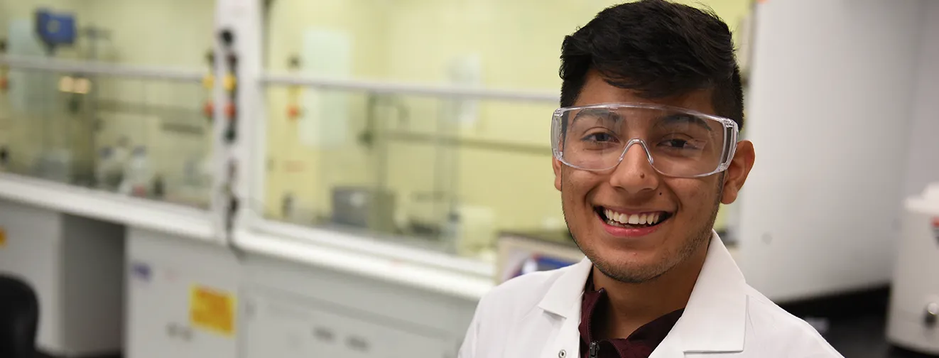 Young man wearing white coat in corporate laboratory