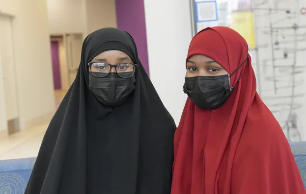 High school and college interns in hospital hallway 