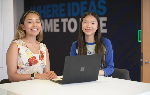 Step Up supervisor and intern sitting at table at Accenture