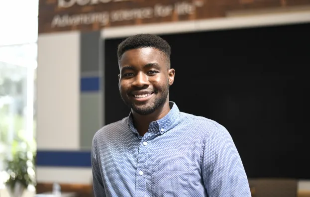 Man standing in office smiling 