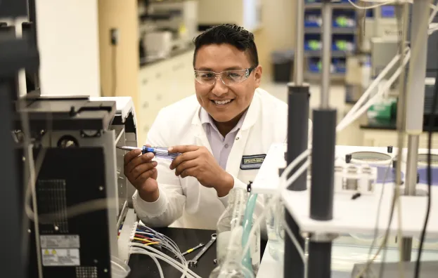 Man wearing lab coat working with technical equipment 