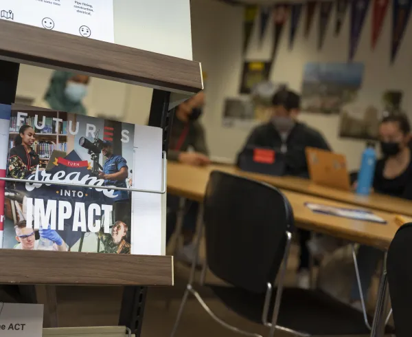 School classroom with students and table and career books