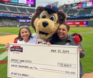 Achieve CEO and development director with TC Bear and big check at Target Field 