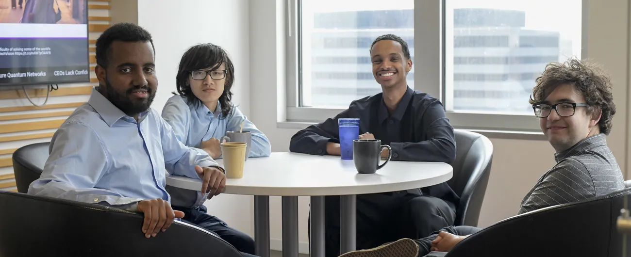 Step Up interns and supervisor at Accenture sitting at table