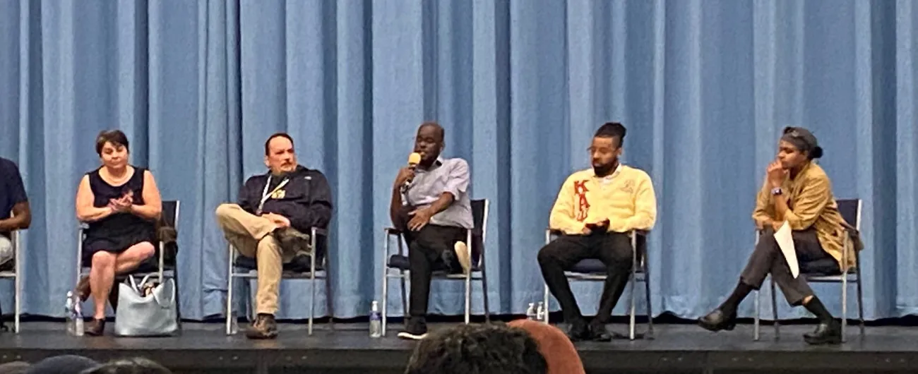 five people sitting on a career panel on a stage