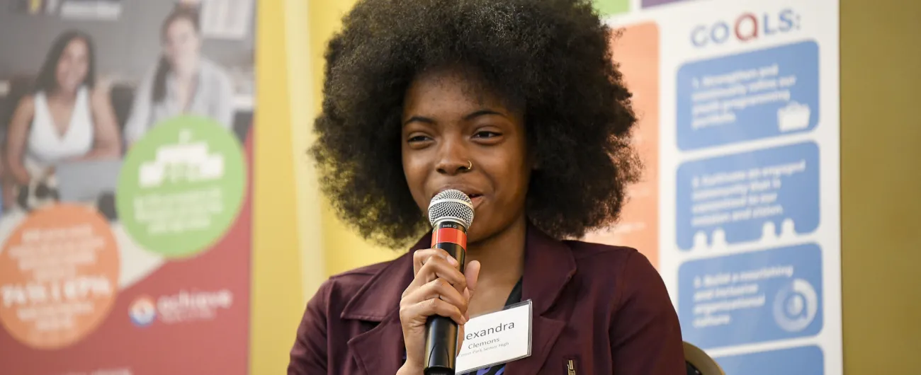 Student with a microphone speaking 