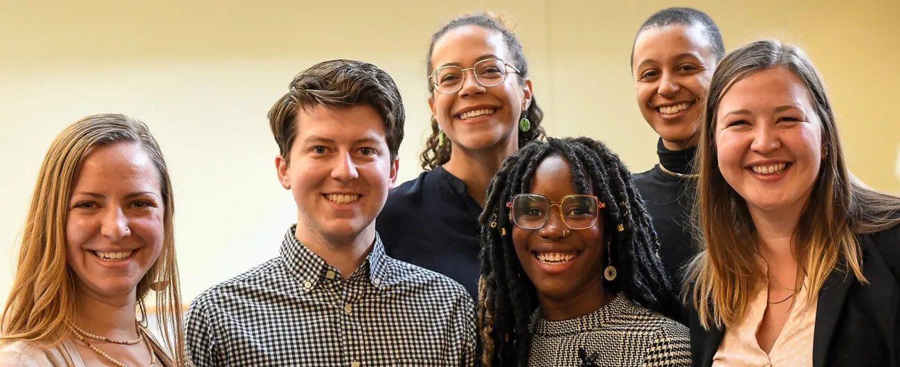 Six Achieve staff standing together and smiling at the camera 