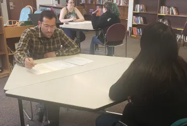 Photo of volunteers interviewing students