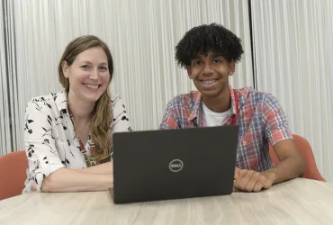 Intern and supervisor sitting in front of a laptop